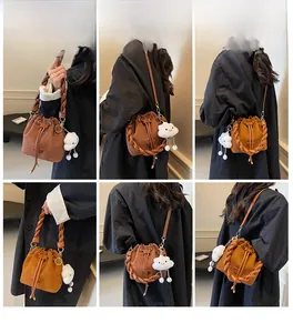 Brown suede bucket bag with woven handle and plush charm shown in multiple angles