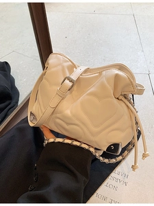 Chic cream heart-quilted shoulder bag with elegant chain strap and metal corners