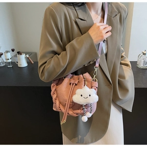 Pink suede bucket bag with drawstring closure and cute plush cloud charm detail