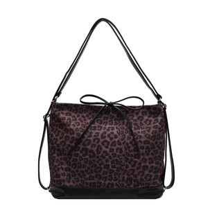 Leopard print tote bag with black leather trim and bow detail on a white background
