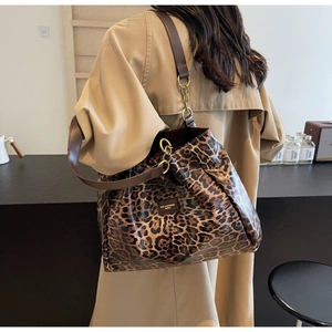 Leopard print tote bag detail showing the shoulder strap and gold chain attachment