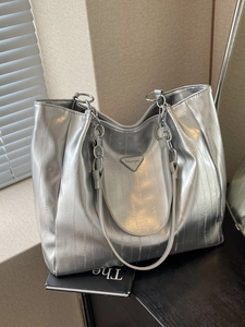 Silver metallic tote bag with chain shoulder strap and textured finish for commuting
