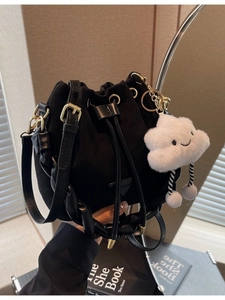 Chic black suede bucket bag with drawstring and cute white cloud pendant detail