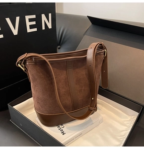Detail of vintage brown suede and leather bucket bag with gold hardware in box