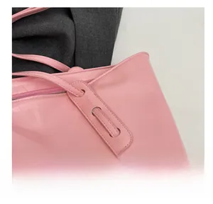 Close-up of pink PU leather handbag showing high-quality stitching and zipper detail