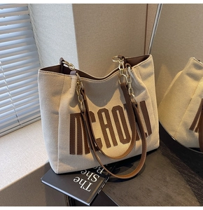 Detail of canvas tote bag with brown leather trim and stylish dual shoulder straps