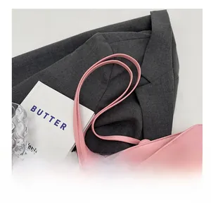 Close-up of comfortable long shoulder strap and leather detail on pink tote bag