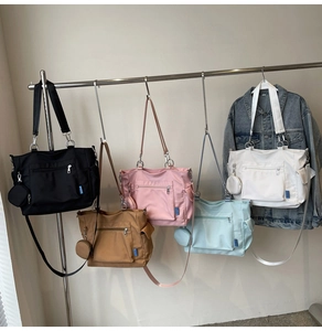 Multiple colors of large capacity nylon tote bags with matching small round pouches