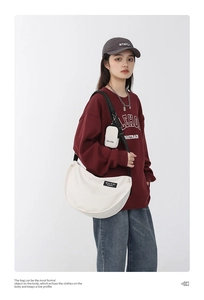 Detail of off-white large capacity nylon crossbody crescent bag with a mini pouch charm