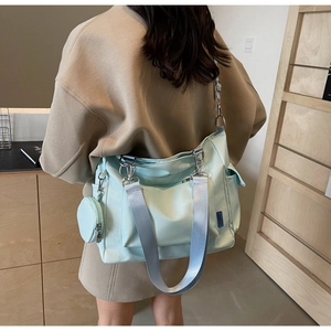 Detail of light blue canvas tote with side pocket and matching small round coin purse