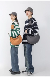 Detail of nylon crescent crossbody bag set with modular mini pouch for casual use