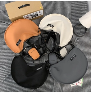 Four colorful crescent nylon crossbody bags with matching coin purses and wide straps