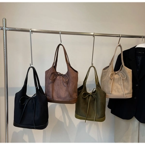 Collection of suede tote bags with bow details in black, coffee, green and beige colors
