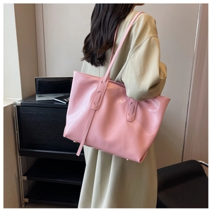 Lifestyle shot of large capacity light pink tote bag worn on shoulder for women