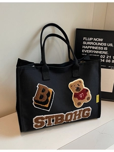 Black canvas tote bag with varsity teddy bear embroidery and large B letter detail