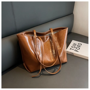 Macro shot of brown wrinkled wax leather texture and spacious interior of the tote bag