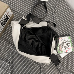 White nylon canvas messenger bag with black lining and large capacity for casual use