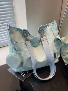 Large mint blue nylon tote bag with wide shoulder strap and round coin purse for daily use