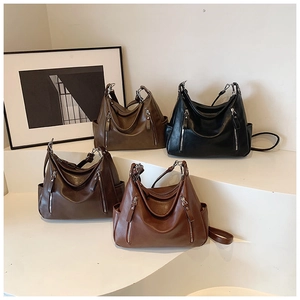 Detail view of large tote bags in black, dark brown, caramel, and burgundy faux leather