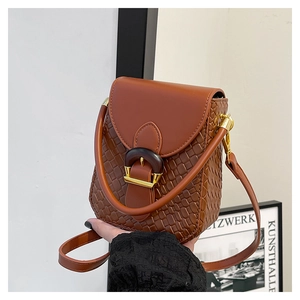 Detail of vintage brown woven leather phone bag with round buckle and golden hardware