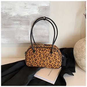Leopardenmuster Kissen-Handtasche mit eleganten schwarzen Griffen in stilvollem Ambiente