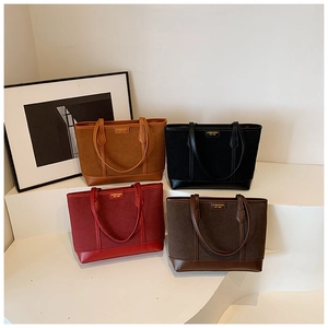 Detail view of four vintage matte tote bags in khaki, black, burgundy and coffee brown
