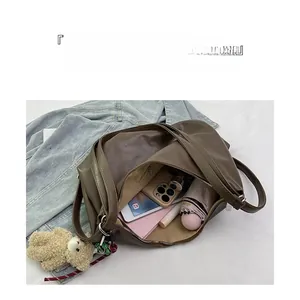 Brown faux leather tote bag interior showing large capacity for laptop and daily items