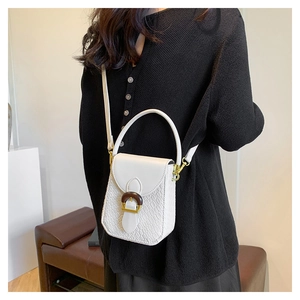 Close-up of white crocodile pattern phone bag with stylish wooden buckle and gold hardware