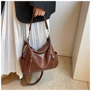 Brown pleated leather tote bag with silver zippers and stylish thick shoulder strap detail
