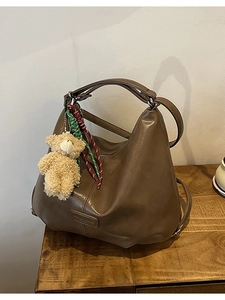 Brown PU leather tote bag with dual handles, shoulder strap, and cute bear charm pendant