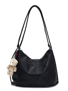 Minimalist black PU leather tote bag with a brown plush bear charm for daily commuting