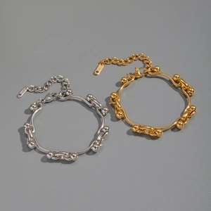 Detailed macro of gold and silver irregular ball chain bracelets in polished stainless steel