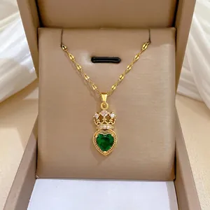Luxurious gold necklace with emerald heart and crown pendant set with white zircons