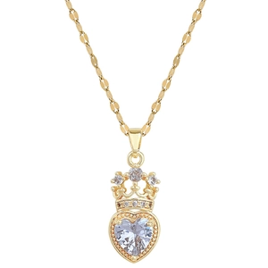 Detailed shot of golden crown heart pendant with sparkling white cubic zirconia stones