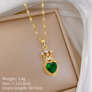 Detail of gold crown necklace with green heart crystal and white zircon pavé setting