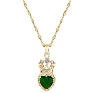 Macro shot of titanium crown necklace with green heart gem and pave diamond details