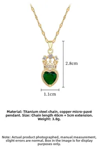 Detailed close-up of a titanium steel heart necklace with a green gem and crown pendant