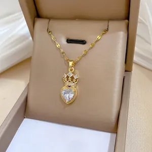 Close-up of gold crown heart pendant necklace with crystals in a luxury jewelry box