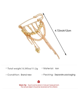Detailed view of punk style gold chain brooch with metal tassels and weight specifications