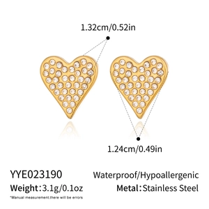 Macro detail of 18K gold plated heart stud earrings with sparkling cubic zirconia