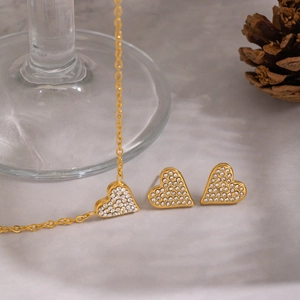 Detailed view of 18K gold plated heart necklace and earrings set with crystal pave