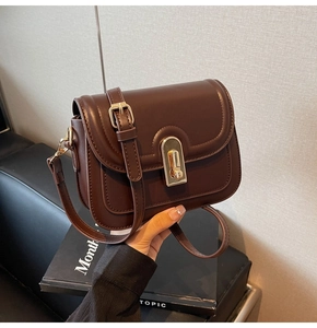 Détails du sac en cuir marron foncé avec un fermoir en métal doré de style vintage