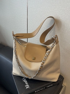 Chic beige canvas and brown leather tote bag with silver chain detail for women