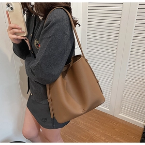 Detailed macro view of large brown lychee grain leather tote bag with FANTOR logo