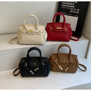 Litchi pattern leather handbags with metal twist locks in four classic colors on display