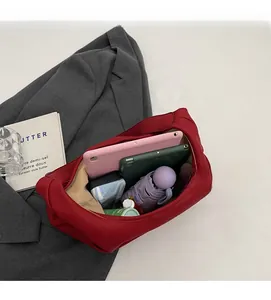 Interior view showing the large capacity of the red pebble leather tote bag with daily items
