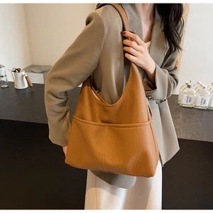 Brown faux leather tote bag with stitch details shown styled for casual daily commuting