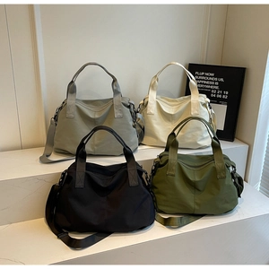 Group shot of large casual tote bags in four colors with wide handles and straps
