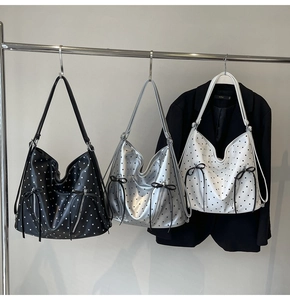 Polka dot tote bags in black, silver, and white with dual bow ribbons and zipper details
