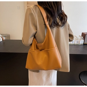 Caramel hobo shoulder bag with litchi texture and front pockets on model view